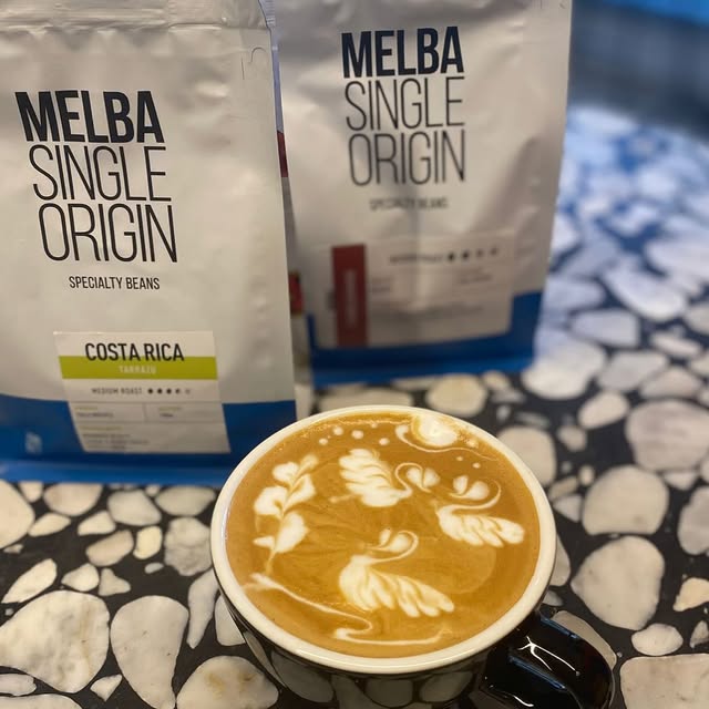 Latte art beside Melba single-origin coffee at Charlie Bit Me