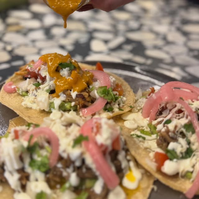 Charlie Bit Me tacos with pickled onion and hot sauce